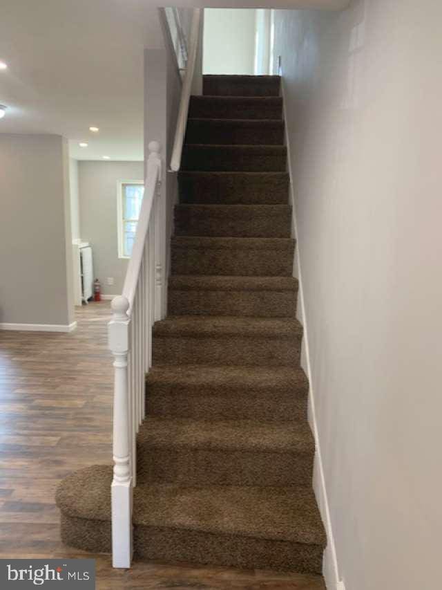 staircase featuring hardwood / wood-style flooring