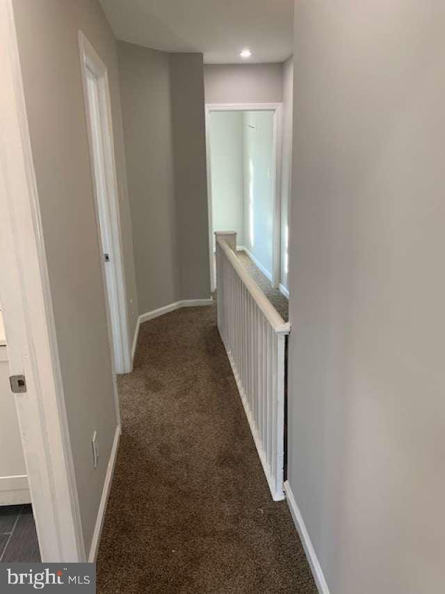 corridor with dark carpet