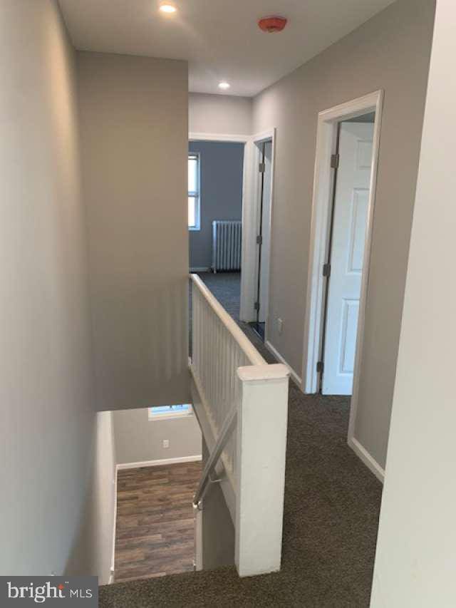 staircase with carpet flooring and radiator