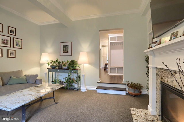 carpeted living room with ornamental molding, beamed ceiling, and a fireplace