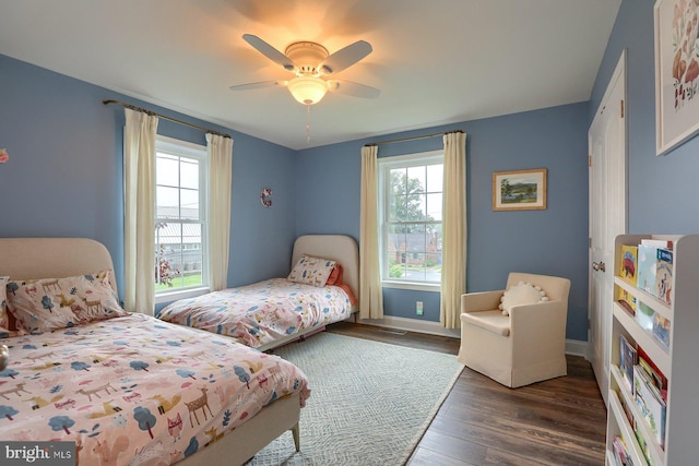 bedroom featuring ceiling fan and dark wood-type flooring