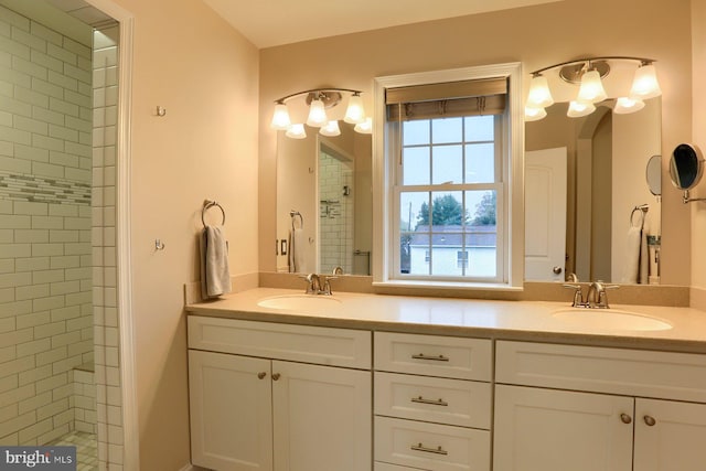 bathroom featuring vanity and tiled shower