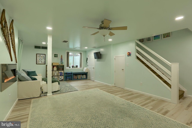 unfurnished living room featuring light wood-type flooring and ceiling fan