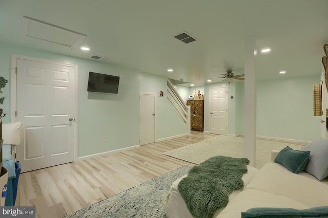 living room featuring light hardwood / wood-style floors and ceiling fan