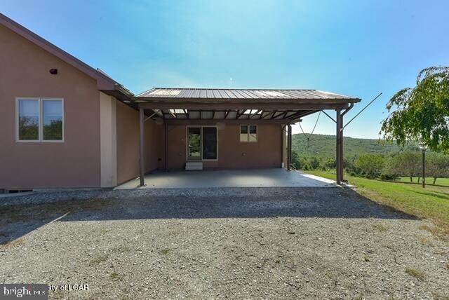 view of vehicle parking with a carport