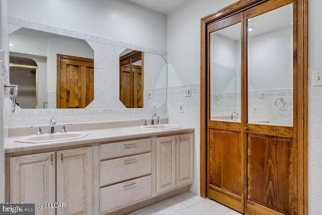 bathroom with tile walls, tile patterned floors, and vanity