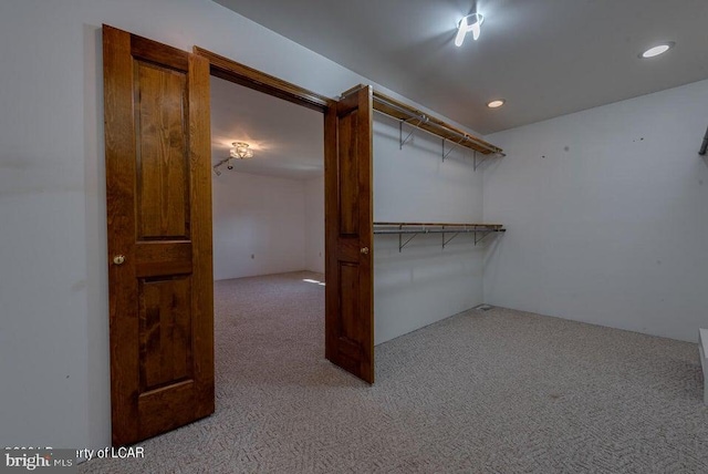 spacious closet featuring light carpet