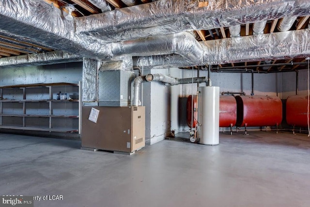 basement featuring gas water heater and heating unit