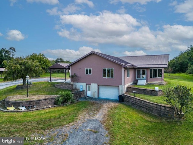 view of front of house featuring a garage and a front lawn