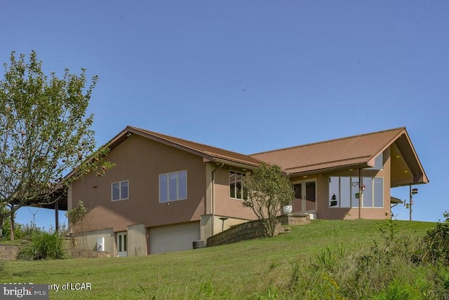 rear view of house with a lawn