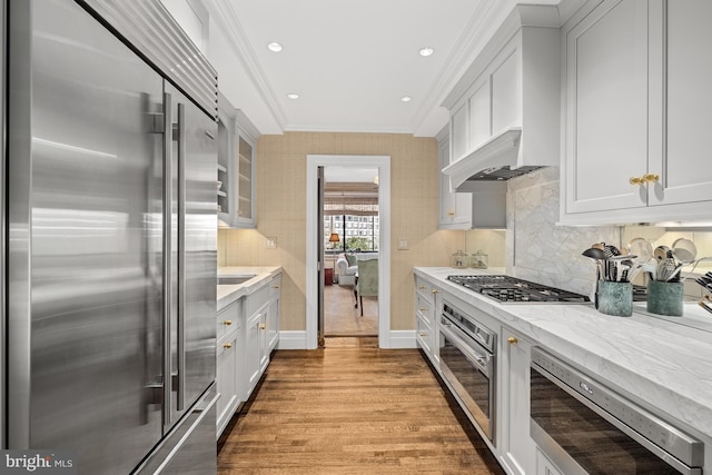 kitchen featuring appliances with stainless steel finishes, ornamental molding, and white cabinetry