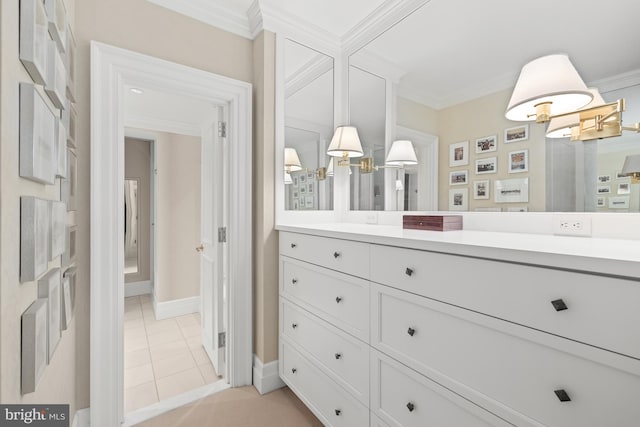 bathroom with vanity, tile patterned flooring, and ornamental molding