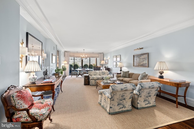 living room featuring wood-type flooring, an inviting chandelier, and ornamental molding