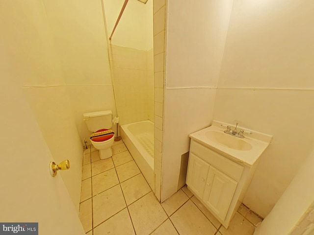 bathroom with vanity, tile patterned floors, toilet, and tiled shower