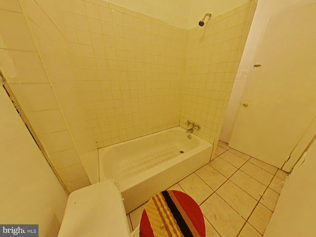 bathroom with tiled shower / bath combo and tile patterned floors