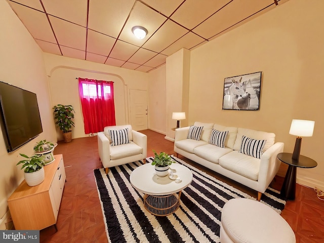 living room with parquet flooring and a paneled ceiling