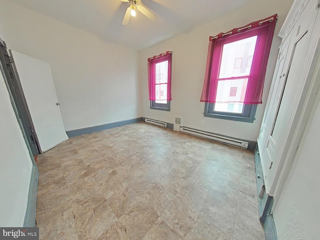 unfurnished bedroom with a baseboard heating unit and ceiling fan