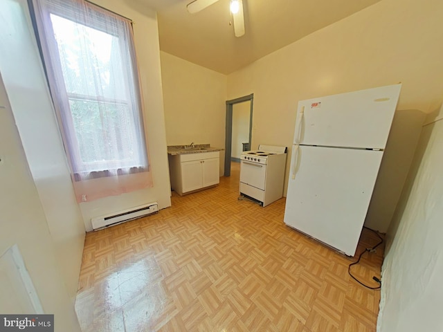 kitchen with a healthy amount of sunlight, white appliances, baseboard heating, and white cabinets