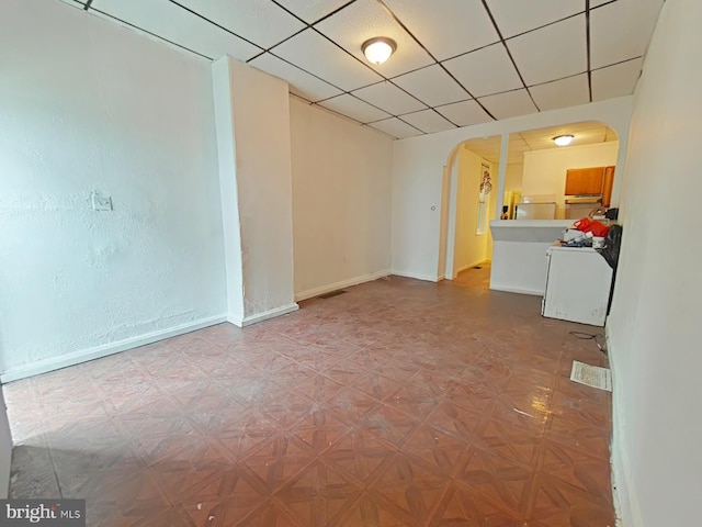 interior space with a paneled ceiling