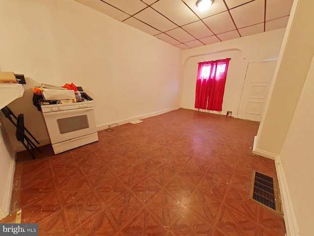 interior space with parquet flooring and a paneled ceiling