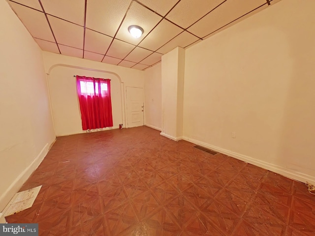 spare room featuring a drop ceiling