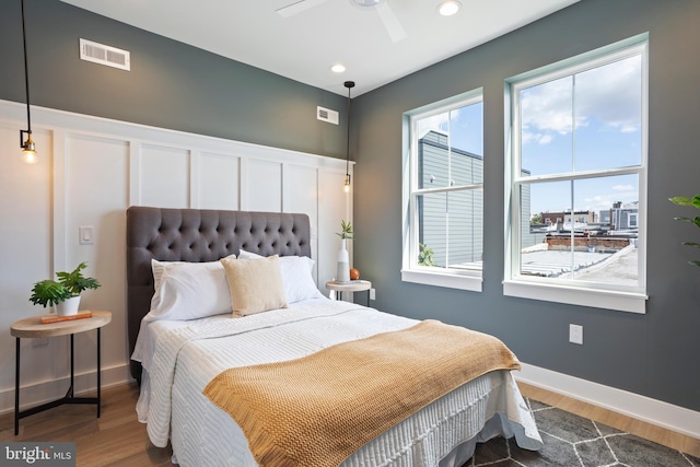 bedroom with ceiling fan and hardwood / wood-style floors