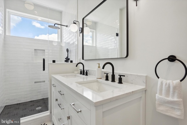 bathroom featuring walk in shower and vanity