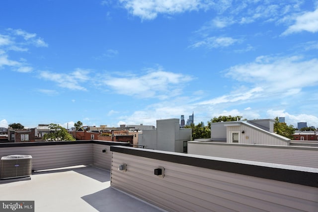 view of patio / terrace with cooling unit and a balcony