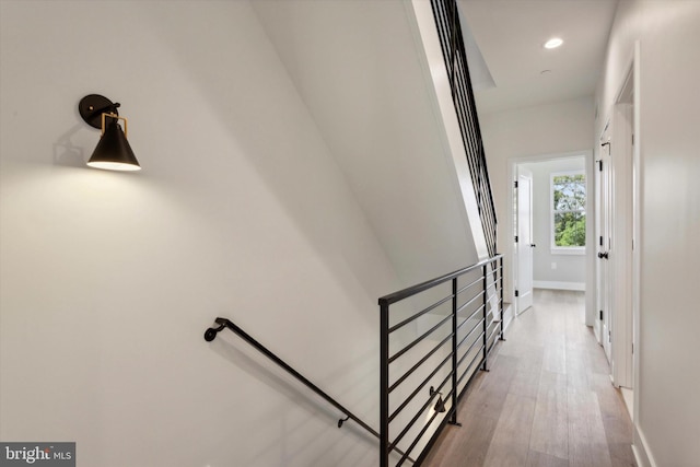 stairs featuring hardwood / wood-style flooring