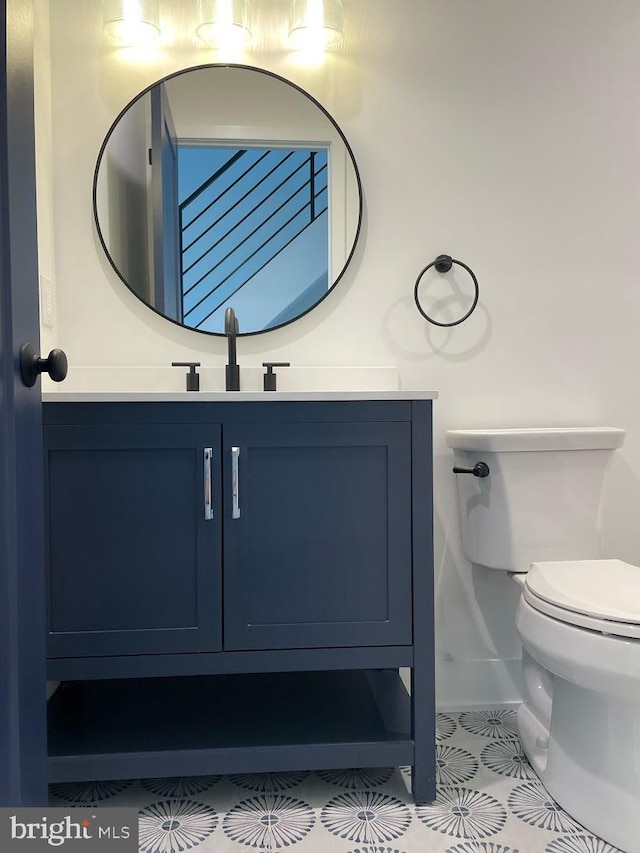 bathroom with vanity, tile patterned flooring, and toilet