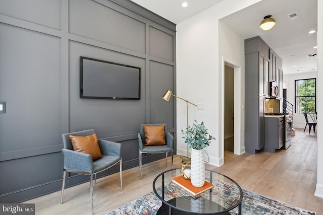 sitting room with light hardwood / wood-style flooring