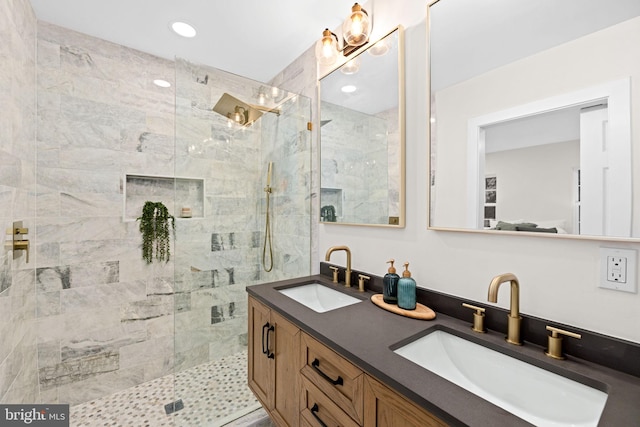 bathroom featuring a tile shower and vanity