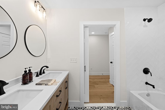 bathroom featuring vanity, tiled shower / bath combo, and hardwood / wood-style flooring