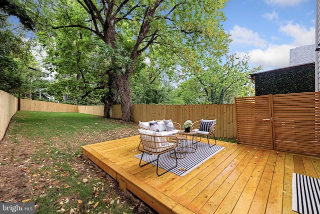 wooden deck featuring a lawn and outdoor lounge area