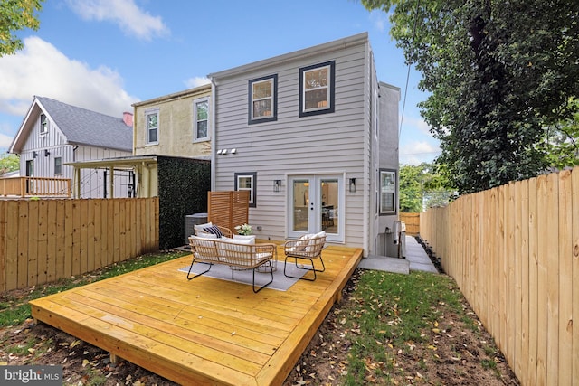 back of house featuring french doors and a deck