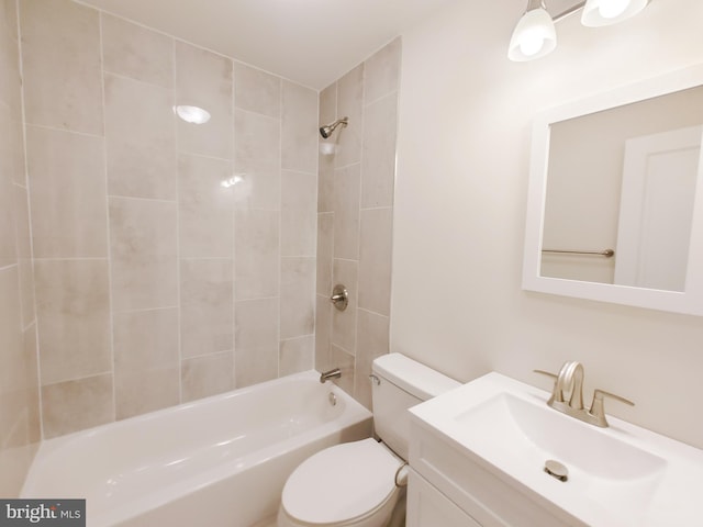 full bathroom with tiled shower / bath combo, vanity, and toilet