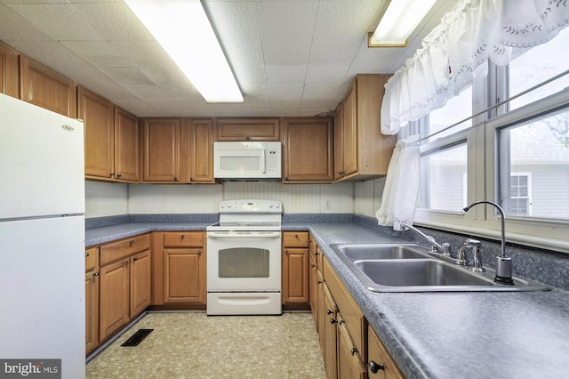 kitchen with sink and white appliances