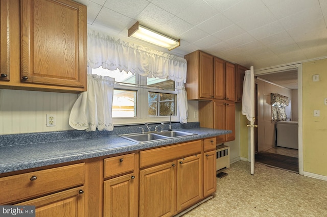 27 S St, Camden, DE 19934 - kitchen with a sink, dark countertops, brown cabinetry, and light floors
