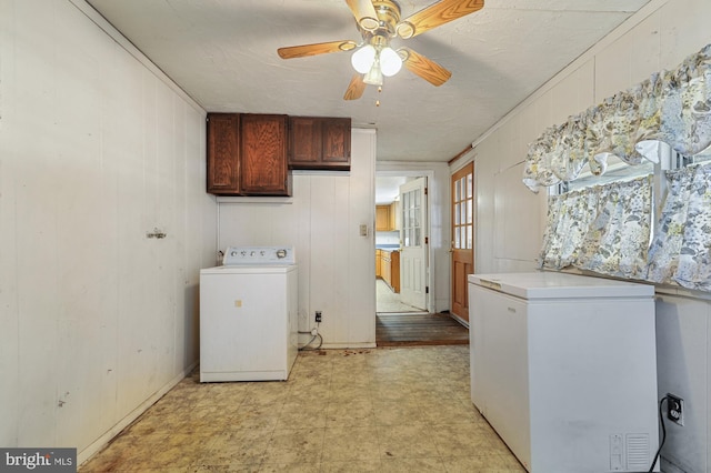 laundry area featuring cabinets, wood walls, ornamental molding, ceiling fan, and washer / clothes dryer