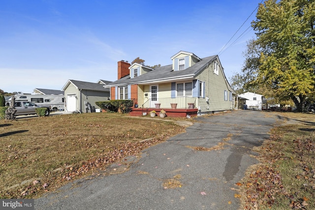 new england style home with a garage and a front yard