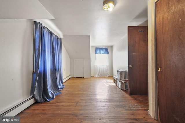 bonus room with hardwood / wood-style flooring and a baseboard radiator