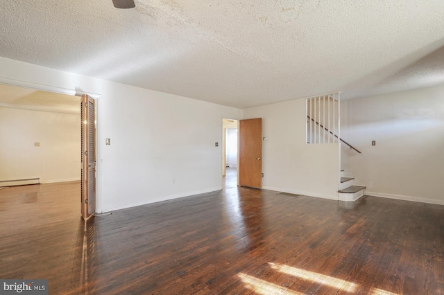 interior space with a textured ceiling, a baseboard radiator, and dark hardwood / wood-style floors