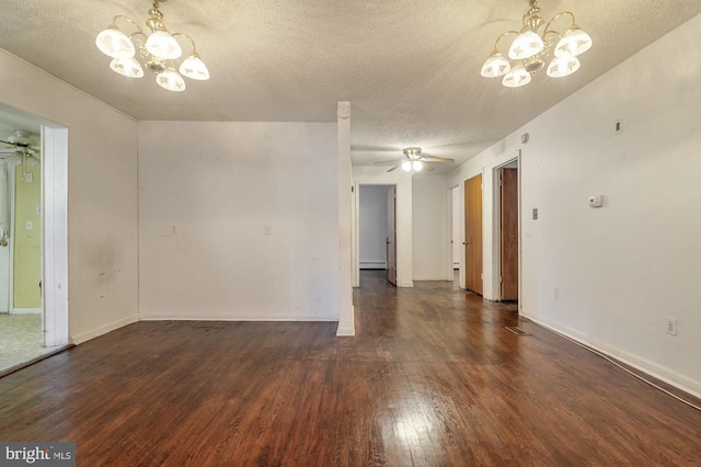 empty room featuring dark wood-type flooring, a textured ceiling, and ceiling fan with notable chandelier