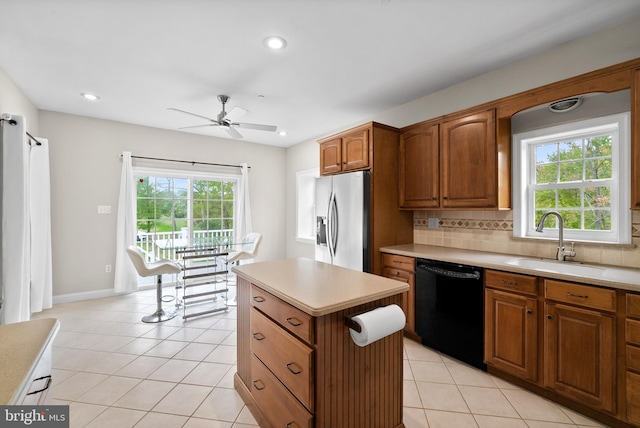 kitchen featuring decorative backsplash, black dishwasher, ceiling fan, stainless steel refrigerator with ice dispenser, and sink