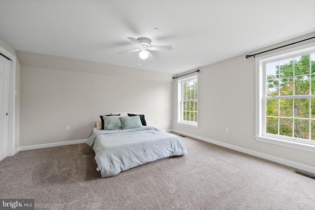 carpeted bedroom featuring ceiling fan