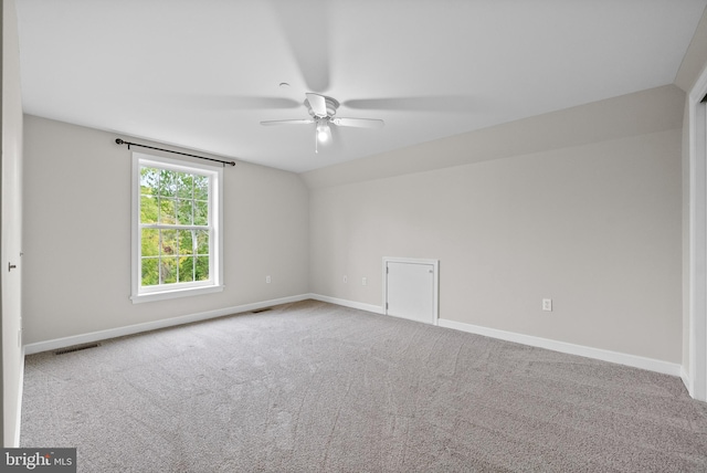 unfurnished room featuring ceiling fan, lofted ceiling, and carpet flooring