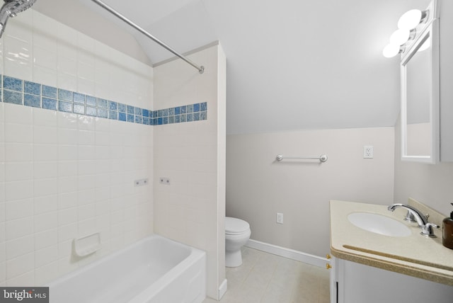 full bathroom with tile patterned floors, tiled shower / bath, vanity, and toilet