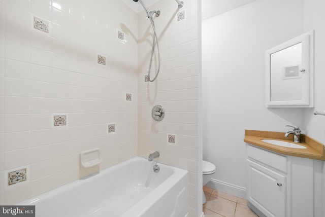 full bathroom with tiled shower / bath combo, tile patterned flooring, vanity, and toilet