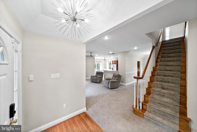 foyer with light wood-type flooring and an inviting chandelier