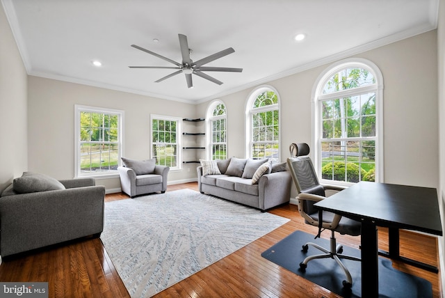 living room featuring a healthy amount of sunlight, crown molding, dark hardwood / wood-style floors, and ceiling fan